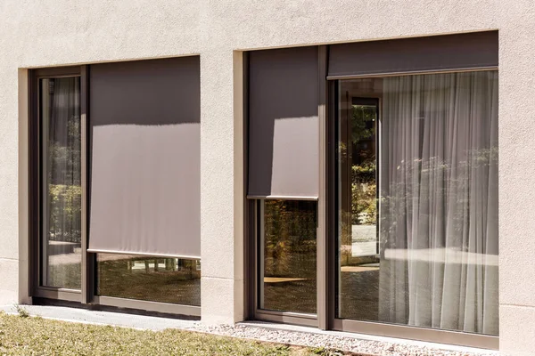 External Roller Blinds Outdoor on Panoramic Windows. Fabric Sun Protection Shutters Outside.