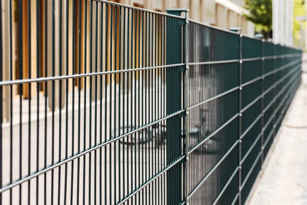 Sectional metal Mesh Fence. Steel grating fence. Sectional fencing installation.