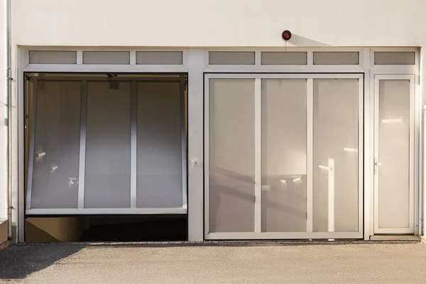 Garage Door to Underground Car Parking of Apartment Building. Modern Sectional Gate to Garage Parking.