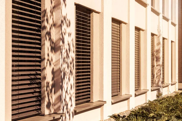 External Blind or Shutters Outdoor Windows of Modern Building on Sunny Day. Sun Protection on Windows.