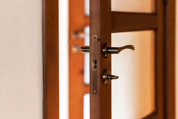 Interior Door with Glass in Apartment. Modern Brawn Wood Door inside Home with Handle Door or Brass Doorknob.