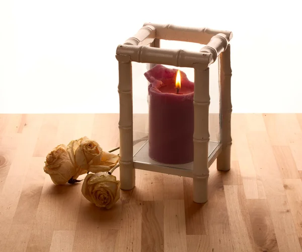 Purple Burning candle in a candlestick — Stock Photo, Image