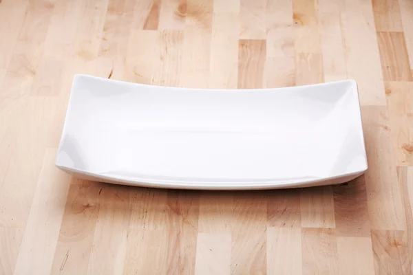 White plate on the table — Stock Image White plate on the table Stock Photo