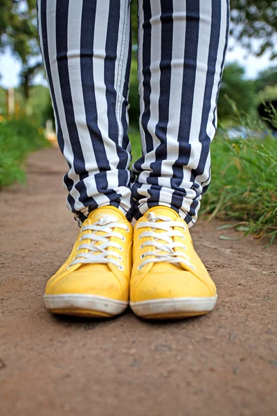 Man in striped pants and orange sneakers — Stock Photo, Image