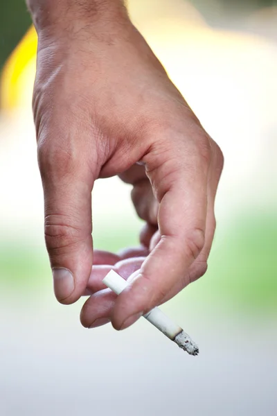 A hand holding a cigarette — Stock Photo, Image