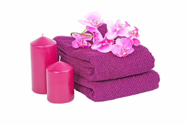 Stack of the multi colored towel with candles and flower — Stock Photo, Image