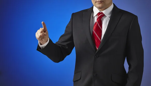 Businessman in a black suit touches the screen — Stock Photo, Image