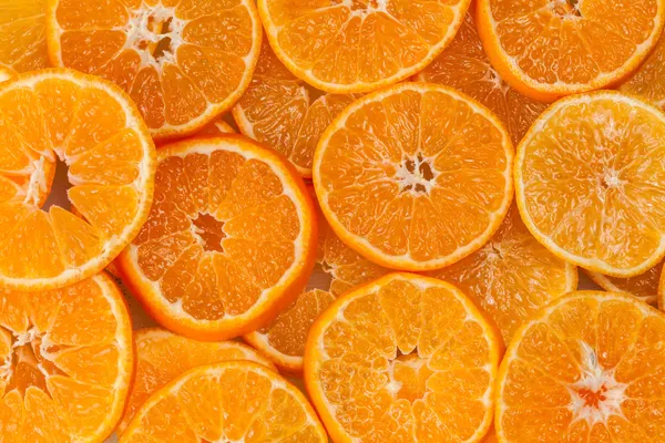 Background from slices of mandarins — Stock Photo, Image