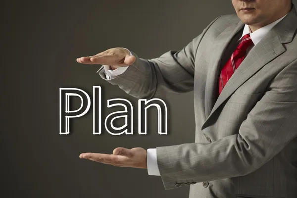 Businessman holding a word Plan — Stock Photo, Image