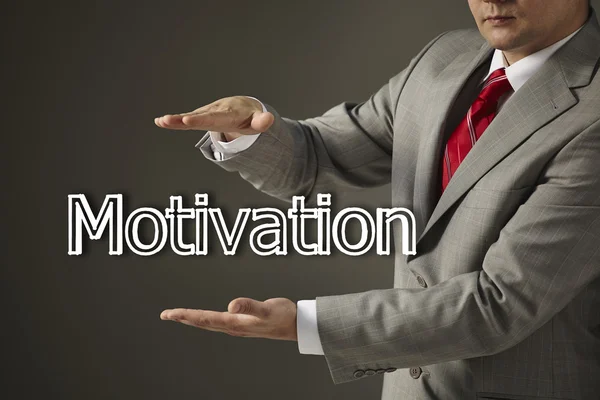 Empresario sosteniendo una palabra Motivación — Foto de Stock