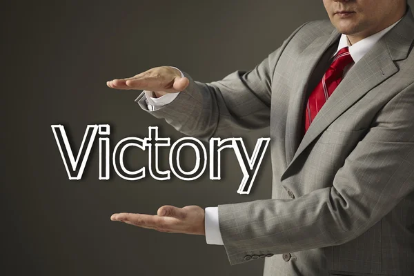 Businessman holding a word Victory — Stock Photo, Image