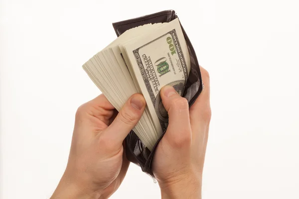 Hand som håller en svart plånbok med pengar — Stockfoto