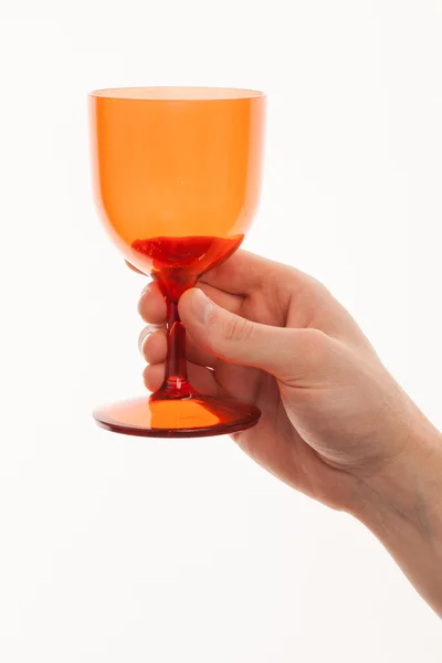 Red glass in a hand isolated on white background — Stock Photo, Image