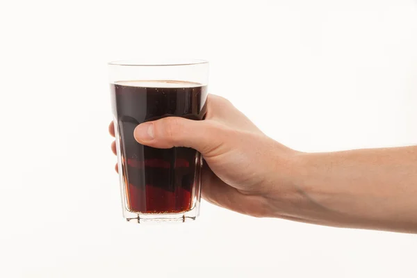 Hand holding fresh cold glass of dark beer or kvass — Stock Photo, Image