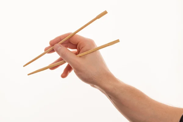 Mężczyzna na białym tle strony gospodarstwa drewniane chopstick — Zdjęcie stockowe