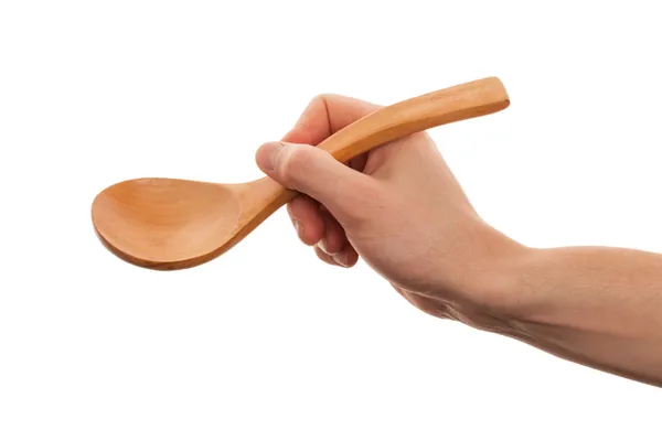 Mano sostiene cuchara de madera. Aislado sobre un fondo blanco — Foto de Stock