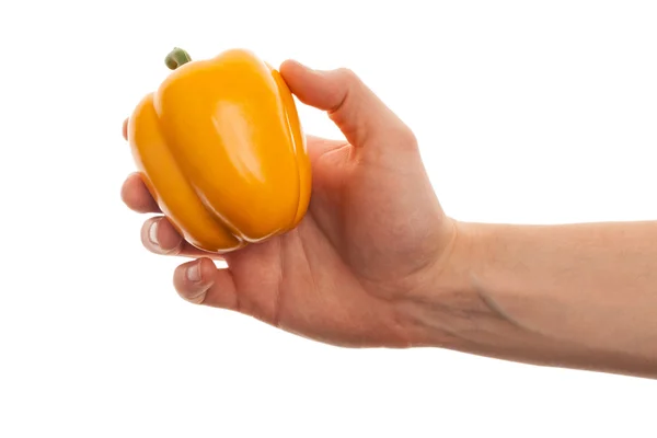 Hand holds yellow pepper — Stock Photo, Image