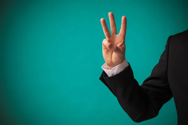 Zakenman hand met drie vingers opdagen — Stockfoto