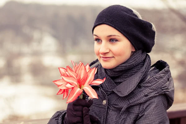 Laughing girl with red flower — Stock Photo, Image