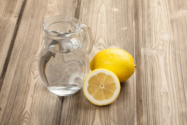 Jar with water and lemons — Stock Photo, Image