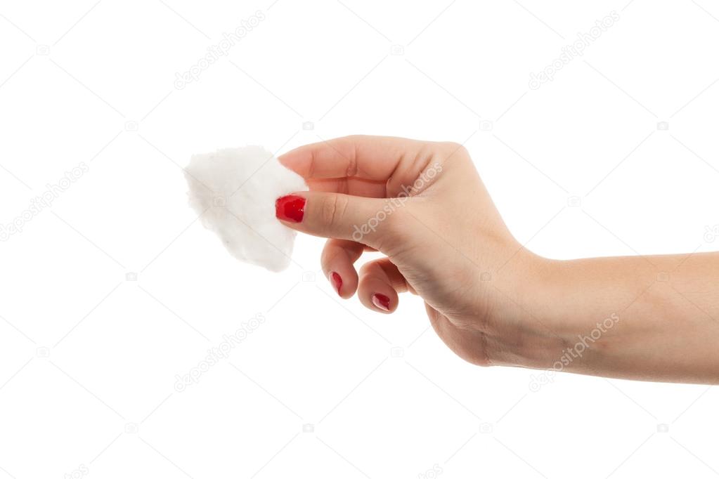 Closeup on cotton pad in hand of woman