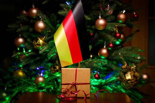 Deutschland-Fahne und Geschenkbox auf dem Hintergrund des Weihnachtsbaums — Stockfoto