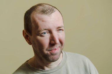 Adam gözlerini kısarak baktı. Surat yapan genç bir adamın portresi