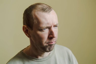 The man frowned. Portrait of a young man making faces.