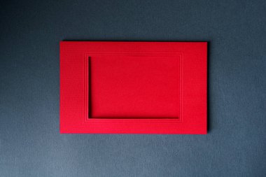 Red cardboard frame on a gray background.