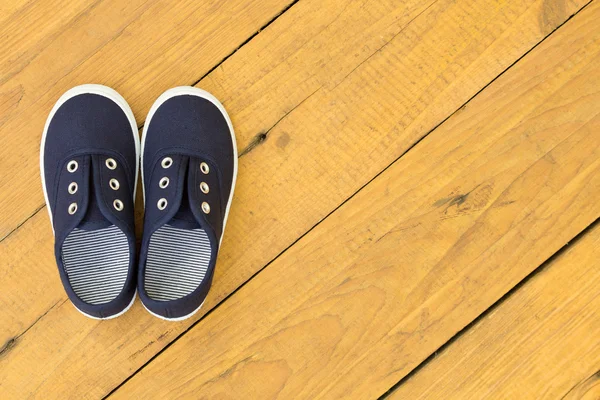 Blue shoes on wooden floor — Stock Photo, Image