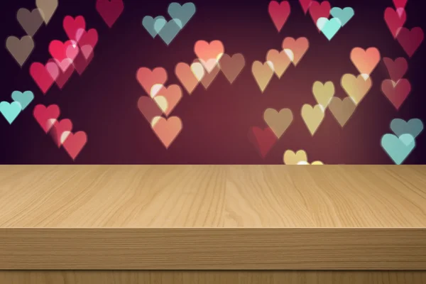 Holiday background with empty wooden table and heart bokeh light — Stock Photo, Image