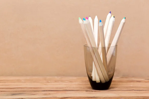 Färg penna i glaset på trä bakgrund — Stockfoto