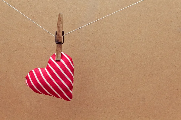 Heart made of cloth hanging on the clothesline — Stock Photo, Image
