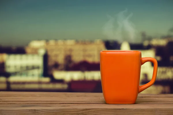 Steaming coffee on the window background. — Stock Photo, Image