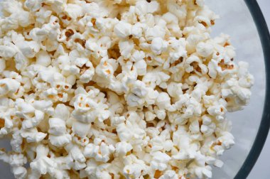 popcorn on a plate. background for popcorn and movie day decoration.