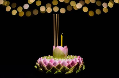 Selective focus on Lotus flower of pink lotus petal krathong on night background with bokeh light for Thailand full moon or Loy krathong festival. clipart