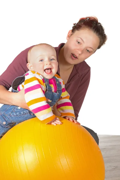 Laughing baby doing exercises — Stock Photo, Image