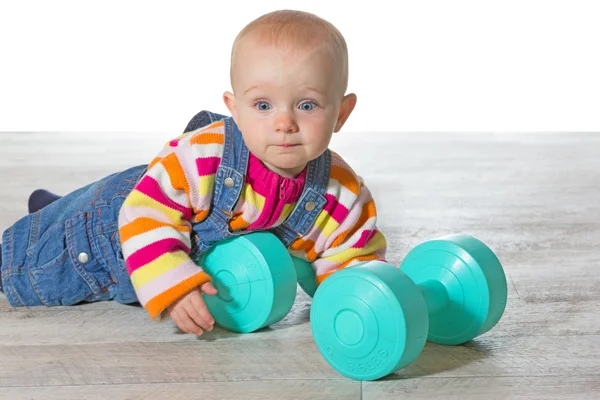 Whimsical baby girl with dumbbells — Stock Photo, Image