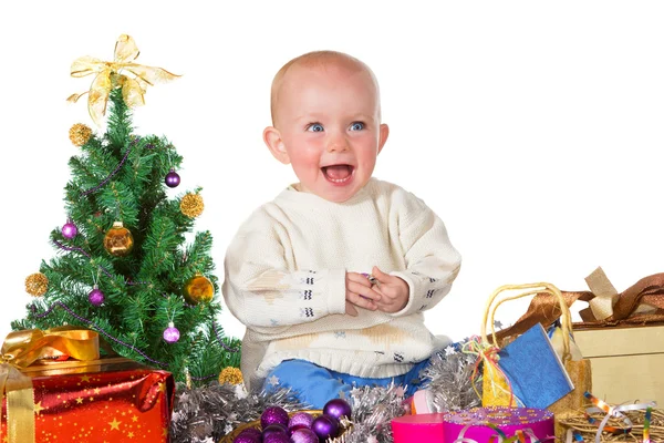 Laughing baby surrounded by Christmas gifts — Stock Photo, Image