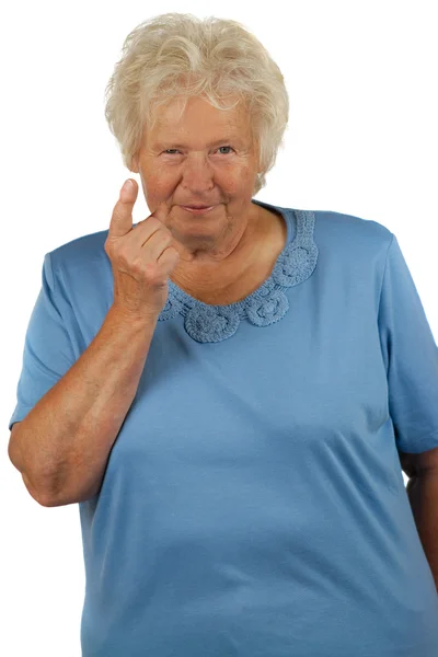 Senior woman with lifted forefinger Stock Picture