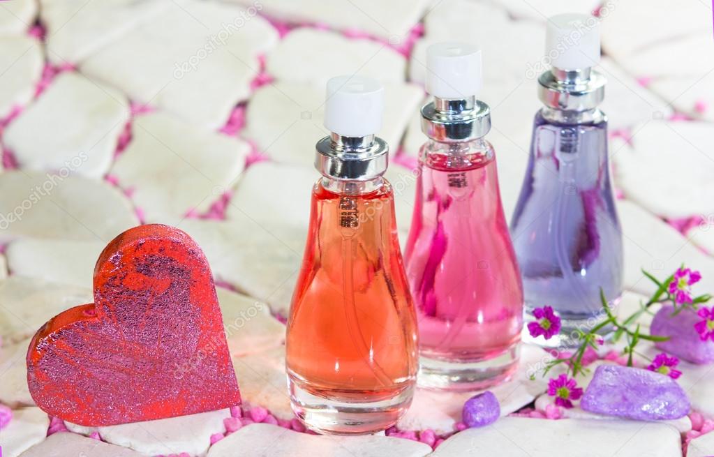 Three bottles of floral fragrance perfume