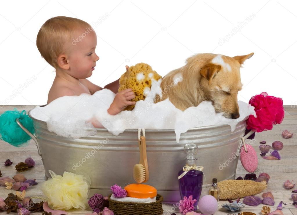 Adorable baby girl bathing with her dog