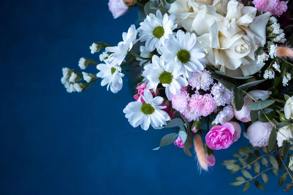 Mavi arka planda bir buket çiçek. Çiçek açan.