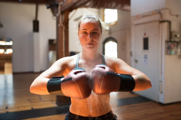 Sporty sportswoman in boxing gloves