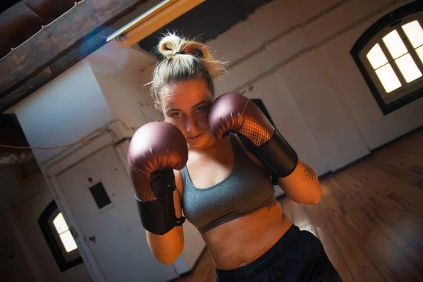 Young woman at boxing training session