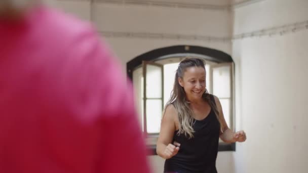 Front view of female instructor dancing in front of group — Stock Video