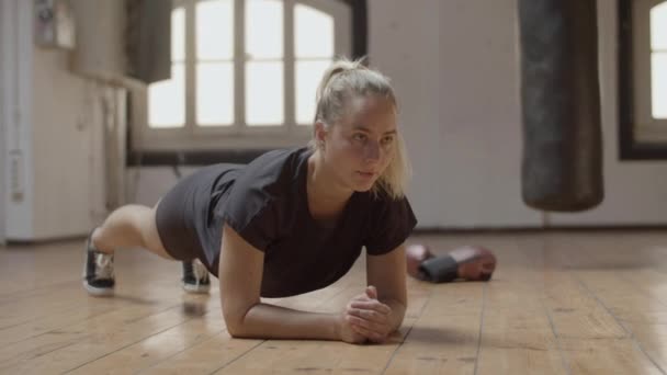 Dlouhý záběr soustředěné a fit ženy, aby prkno cvičení — Stock video