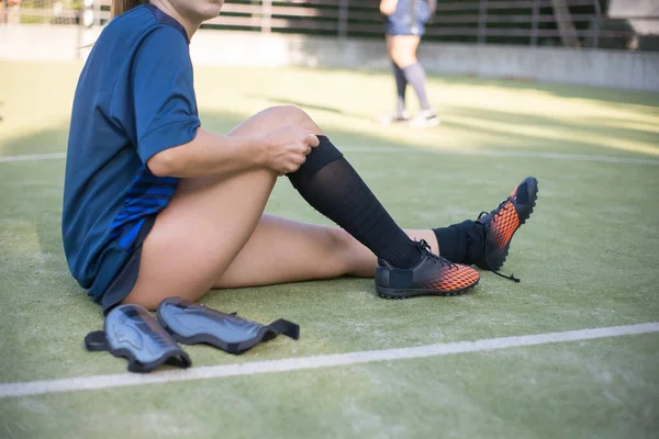 Close-up of young woman getting dressed for training