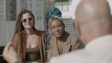 Dışarıdaki meslektaşıyla şakalaşan mutlu kadınların ön görüntüsü.