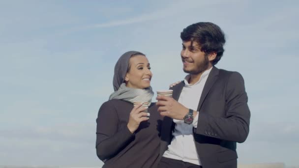 Arabic couple standing outdoor and drinking coffee while dating — 图库视频影像